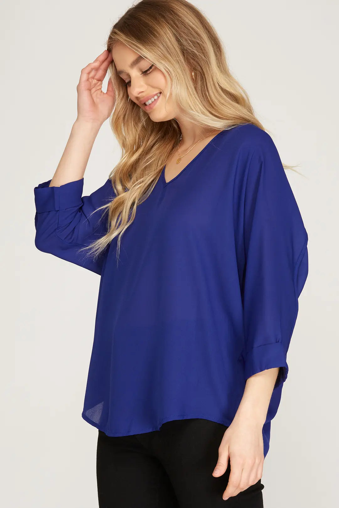 This 3/4 sleeve V-neck woven top, crafted from