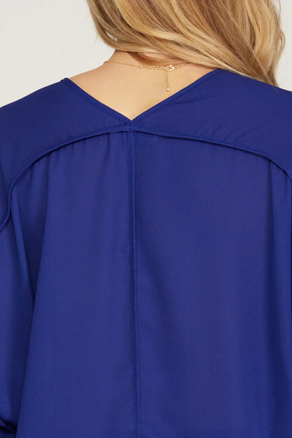 This 3/4 sleeve V-neck woven top, crafted from