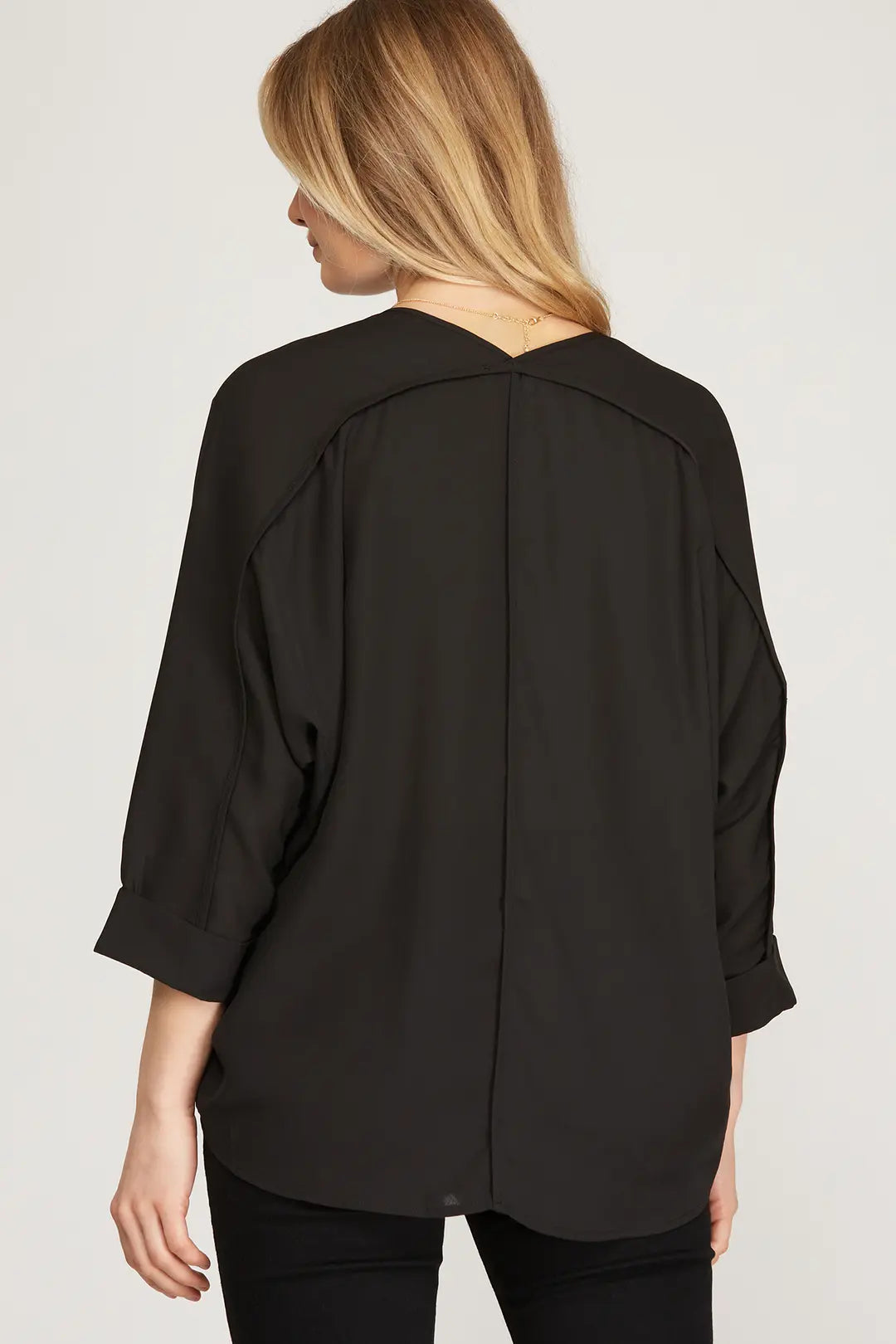 This 3/4 sleeve V-neck woven top, crafted from